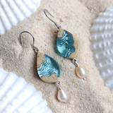 Bay small beach sand and pearl dangle earrings on sand