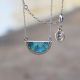 Dainty beach sand and blue resin necklace with beach background