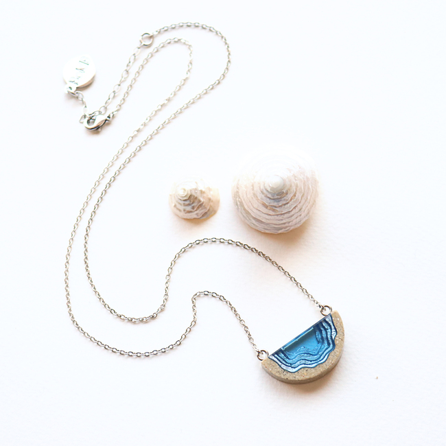 Dainty beach sand and blue resin necklace with white background